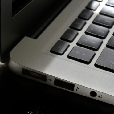 Free Detailed view of a silver laptop showing keyboard and multiple ports. Stock Photo